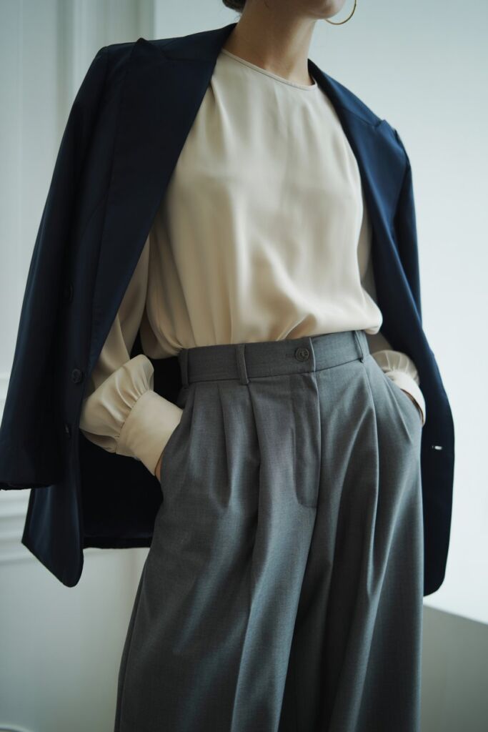 Flowy blouse tucked into tailored wide-leg trousers with blazer