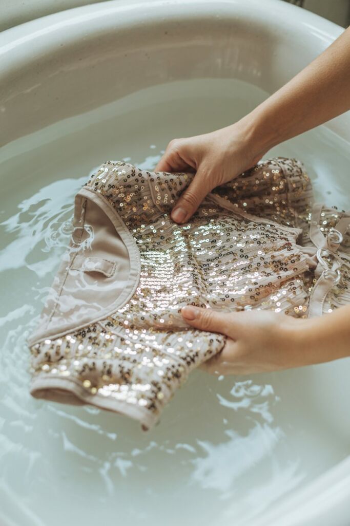 Hand-washing a sequin blouse in cool water