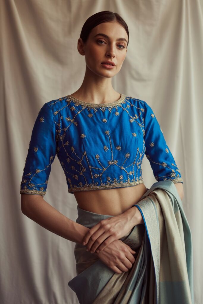 Model in embellished royal blue blouse paired with saree