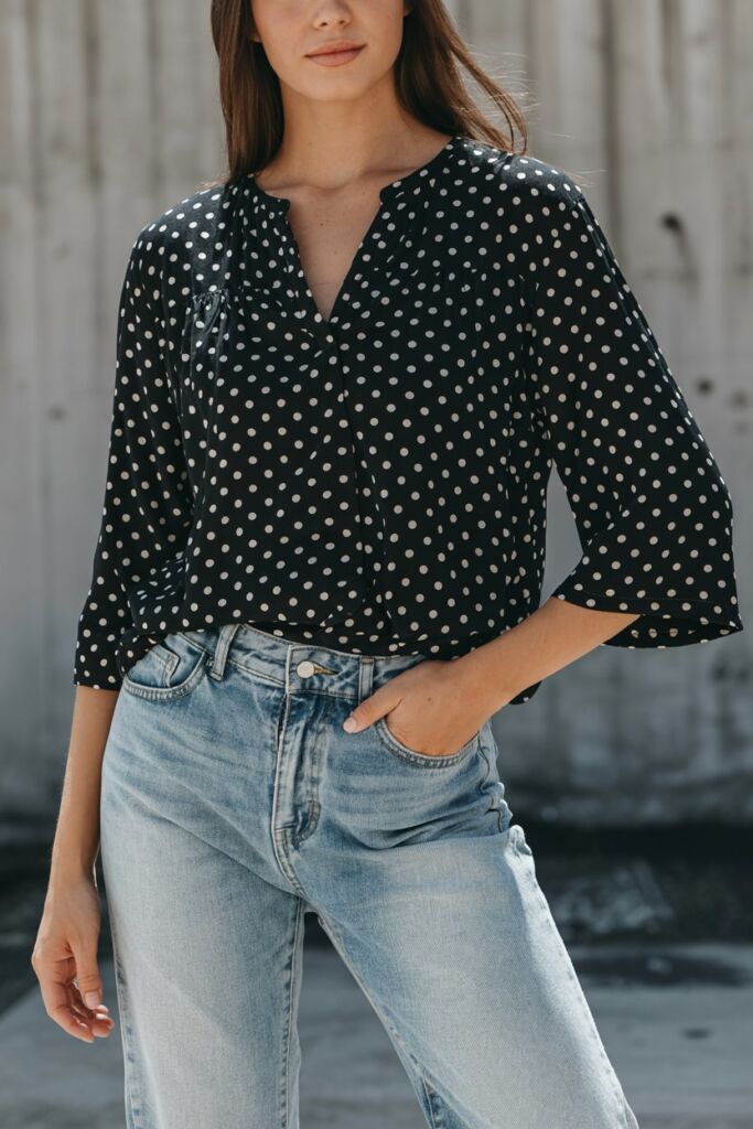Polka dot blouse with jeans 2026 styling black polka dot blouse layered over light wash jeans, urban fashion