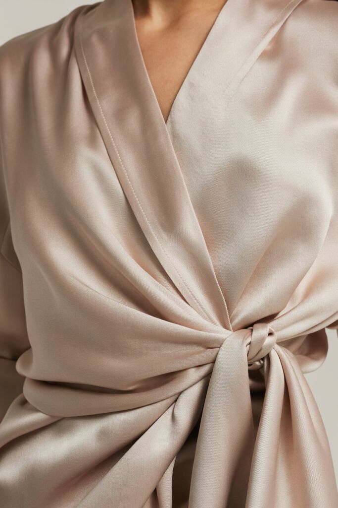 silk wrap blouse tie detail showing fabric crossing and knot